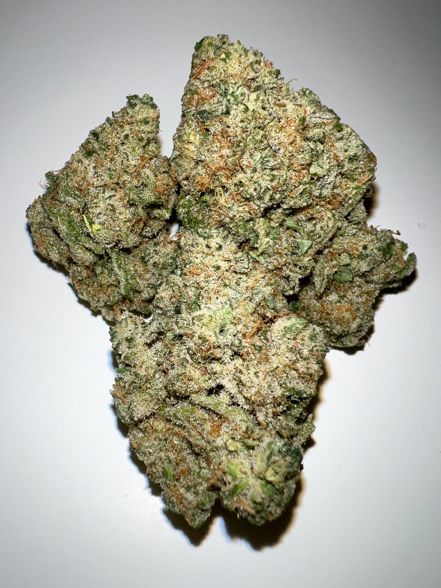 Sunshine strain by Highway Dispos: bright sativa-leaning bud with vivid orange pistils on hessian linen.